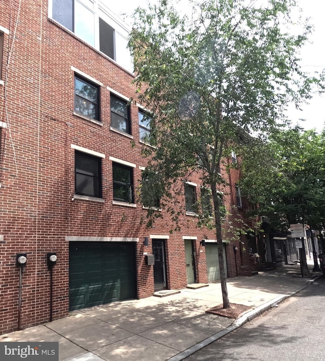 view of property with a garage and driveway