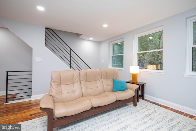 living room with stairs, baseboards, wood finished floors, and recessed lighting