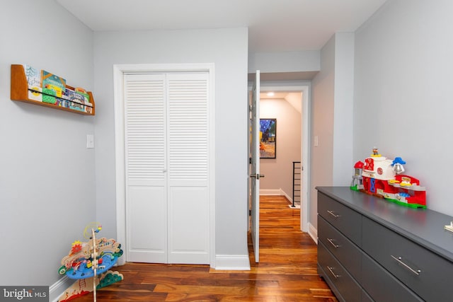 playroom featuring dark wood-style flooring and baseboards