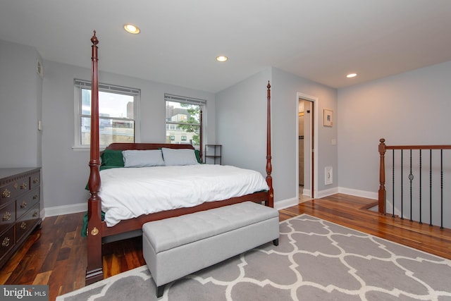 bedroom featuring baseboards, dark wood-style flooring, and recessed lighting