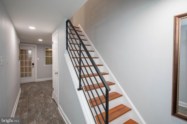 stairway featuring recessed lighting, baseboards, and wood finished floors