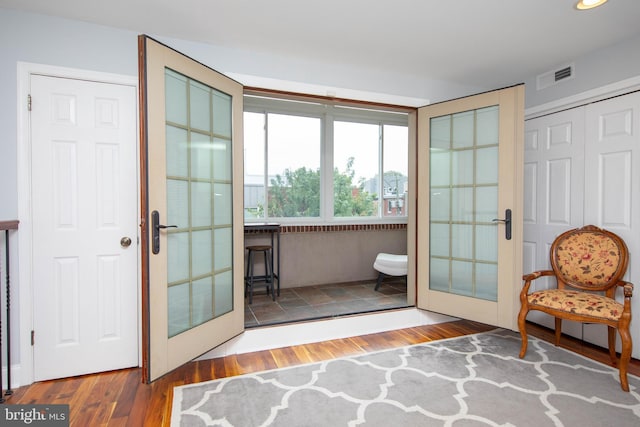 doorway featuring visible vents, wood finished floors, and french doors