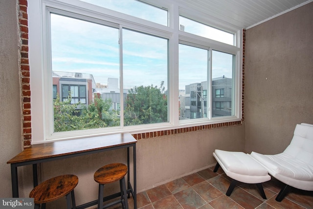 sitting room with a view of city and ornamental molding