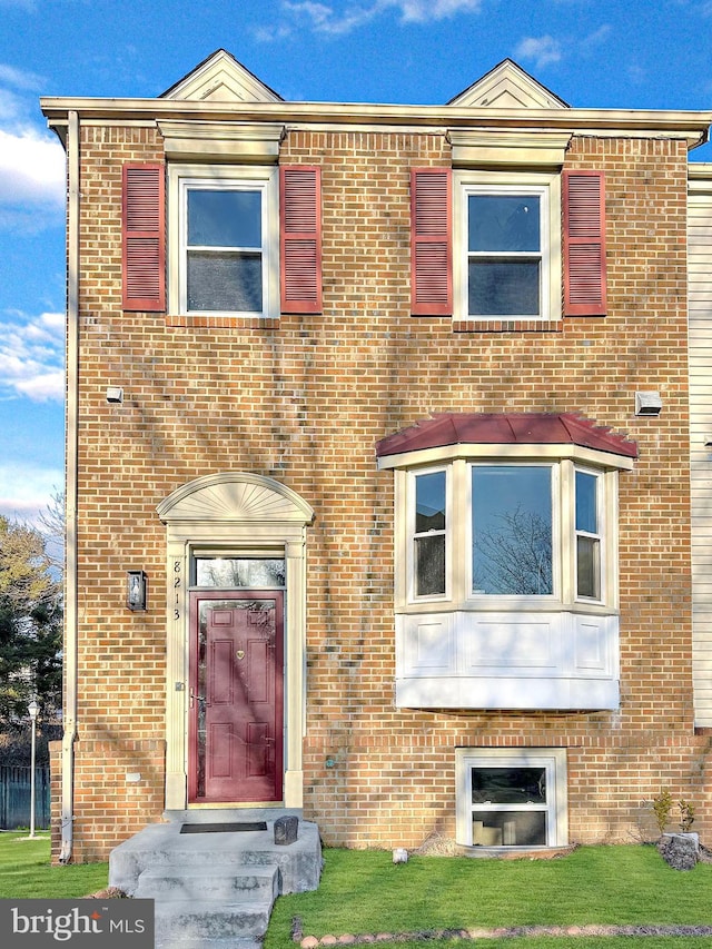 townhome / multi-family property with brick siding