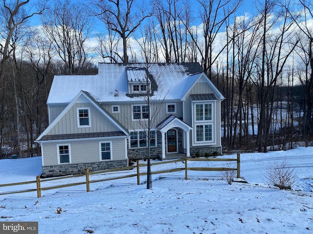 view of front of house featuring stone siding and board and batten siding