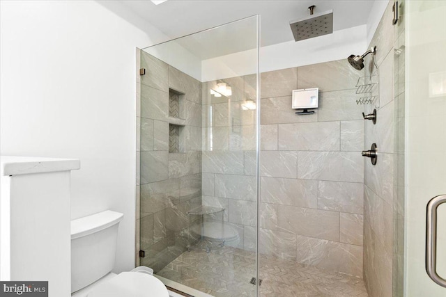 bathroom featuring a shower stall and toilet