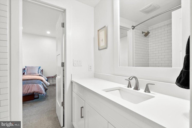 bathroom featuring ensuite bath, visible vents, walk in shower, and vanity