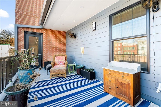 view of patio featuring a balcony