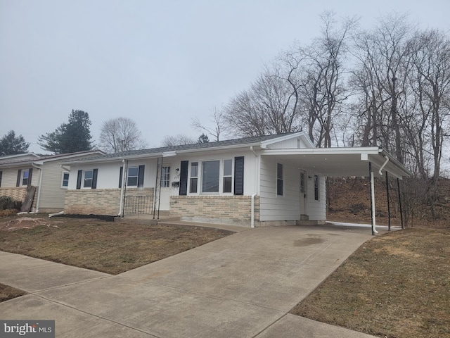 ranch-style house with a carport, a front lawn, and concrete driveway