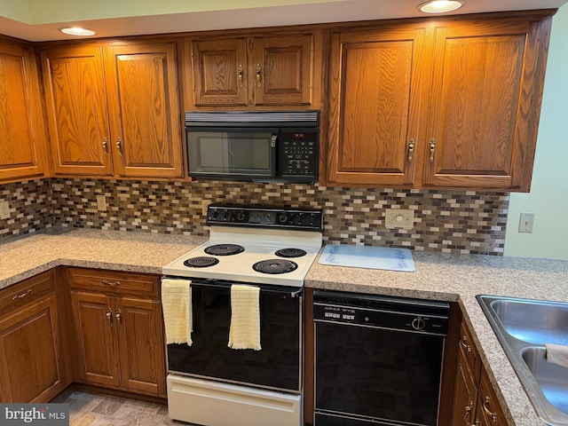 kitchen with black appliances, light countertops, backsplash, and brown cabinetry