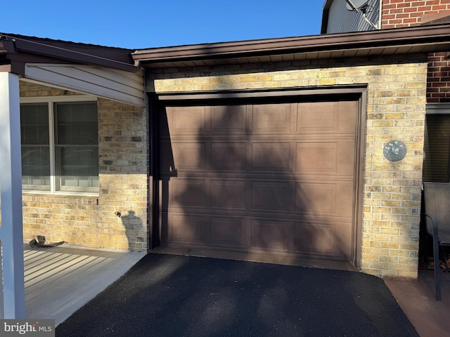 garage with aphalt driveway