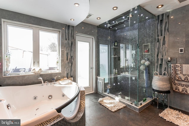 bathroom with a stall shower, visible vents, and a tub with jets