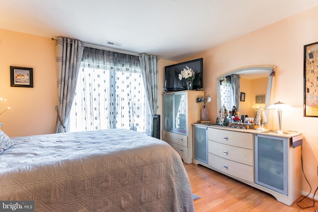 bedroom featuring light wood-style flooring and visible vents