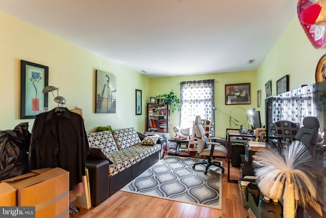 living area featuring wood finished floors and visible vents