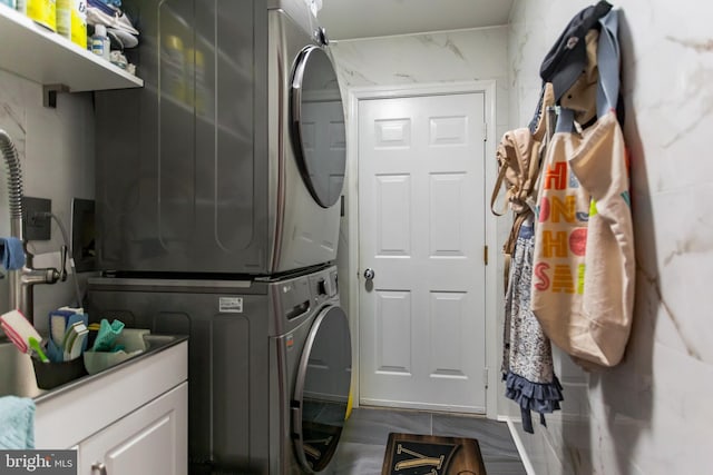 laundry room featuring laundry area and stacked washing maching and dryer