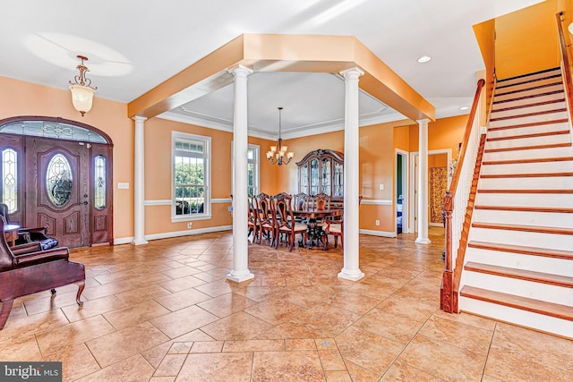 entrance foyer with decorative columns, baseboards, stairs, a notable chandelier, and recessed lighting