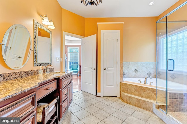 bathroom featuring a stall shower, tile patterned flooring, vanity, and a bath