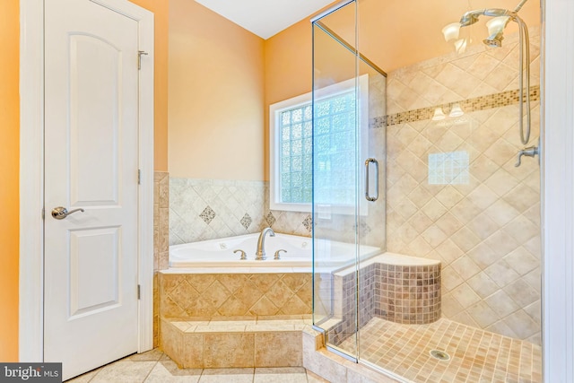 full bath with a shower stall, a bath, and tile patterned floors