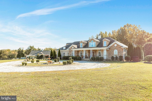 view of front of home with a porch and a front yard