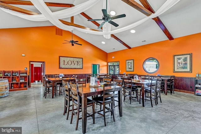 dining area featuring high vaulted ceiling, beamed ceiling, visible vents, and finished concrete floors