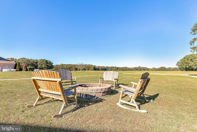 view of yard with a rural view and a fire pit