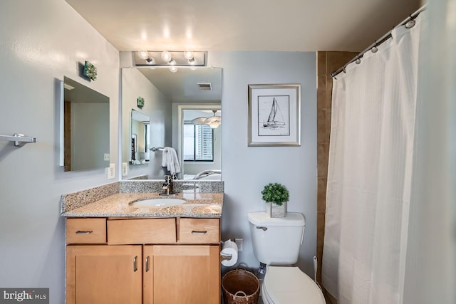 full bathroom featuring a shower with curtain, visible vents, vanity, and toilet