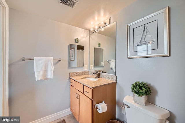 full bathroom featuring toilet, baseboards, visible vents, and vanity