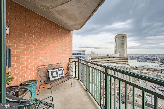 balcony with a water view and a view of city