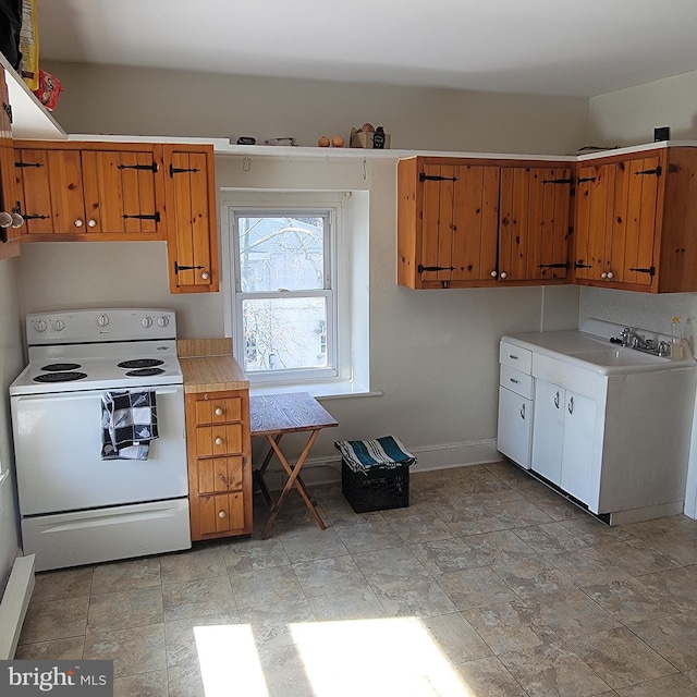 kitchen featuring white range with electric cooktop, light countertops, brown cabinetry, a sink, and baseboards