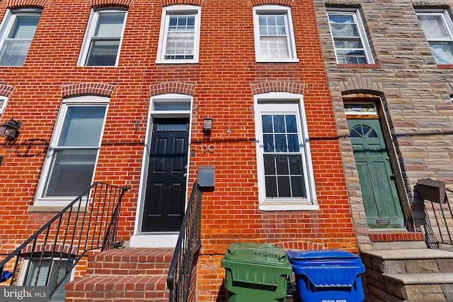 view of exterior entry featuring brick siding