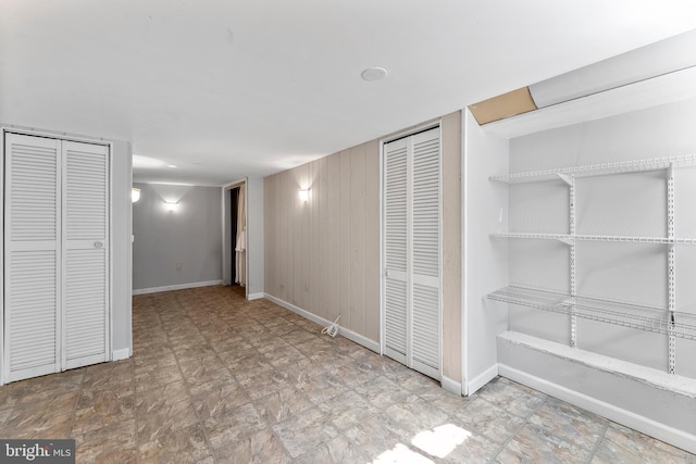 interior space featuring wooden walls and baseboards