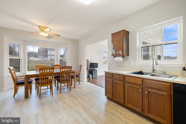 dining space with light wood-style floors, ceiling fan, and baseboards