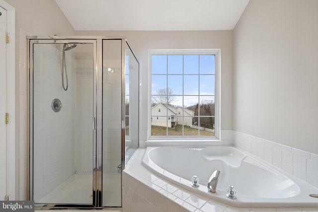 bathroom with a garden tub and a shower stall