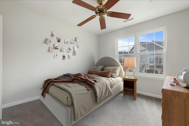 bedroom with carpet floors, visible vents, baseboards, and ceiling fan