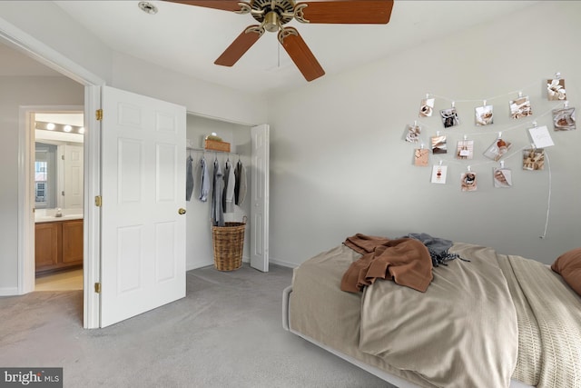 bedroom with light carpet, ceiling fan, a closet, and baseboards