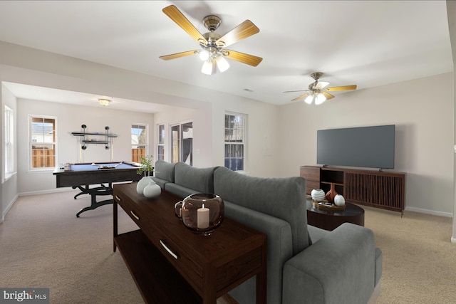 living room featuring baseboards, pool table, a ceiling fan, and light colored carpet