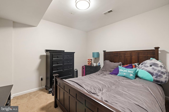 bedroom with baseboards, visible vents, and light colored carpet