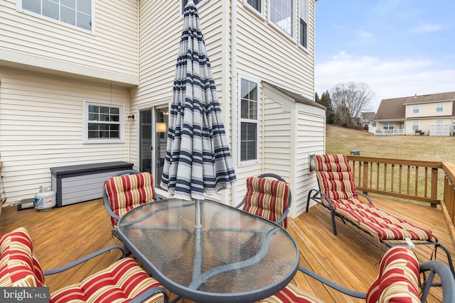 wooden terrace featuring outdoor dining area