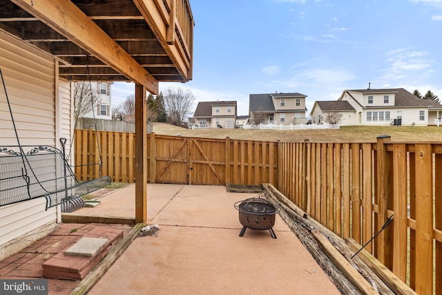 view of patio / terrace with an outdoor fire pit, a gate, and fence