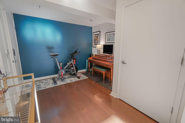 interior space featuring baseboards and wood finished floors