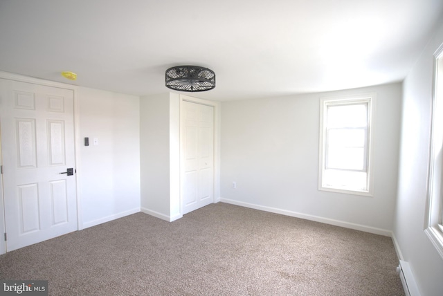 unfurnished bedroom featuring carpet, a closet, and baseboards