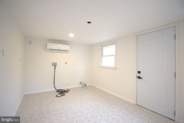 washroom with hookup for a washing machine, laundry area, a wall mounted air conditioner, and baseboards