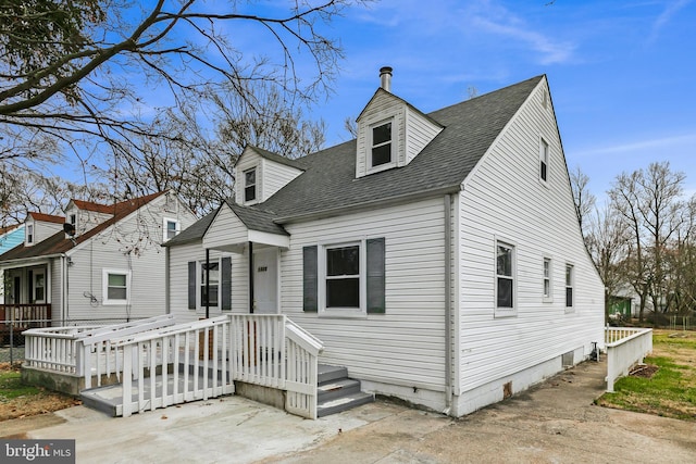 cape cod-style house featuring a shingled roof