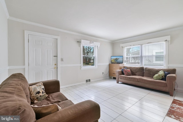 tiled living room with visible vents, ornamental molding, and baseboards