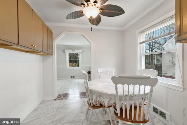 dining area featuring ornamental molding, visible vents, and a healthy amount of sunlight