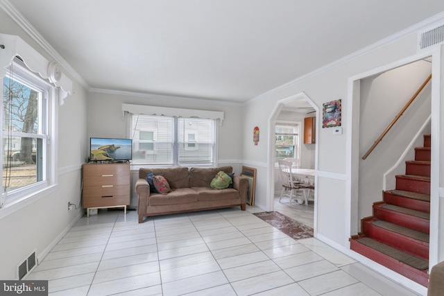 living room featuring stairs, visible vents, arched walkways, and light tile patterned flooring