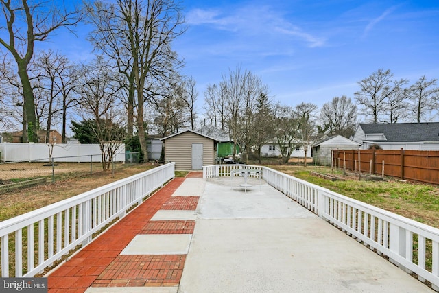 exterior space featuring a storage shed, an outdoor structure, and a fenced backyard