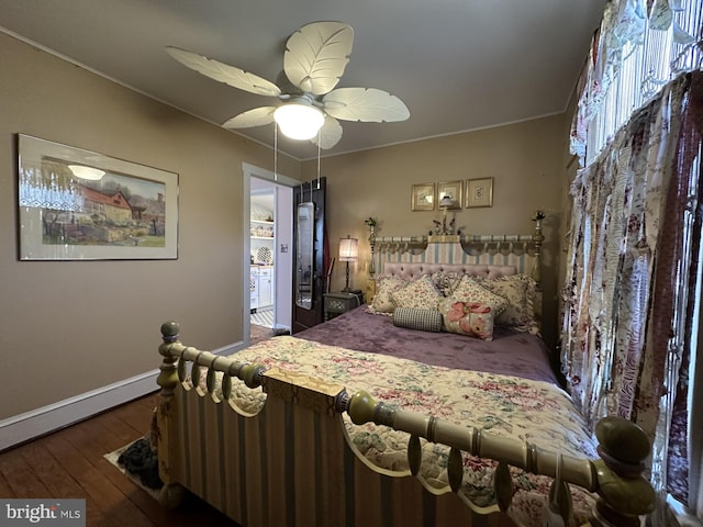 bedroom with hardwood / wood-style flooring, a ceiling fan, and baseboards