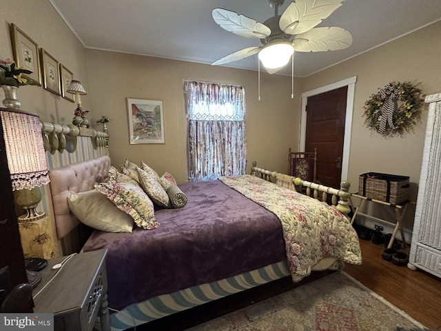 bedroom featuring crown molding, ceiling fan, and wood finished floors