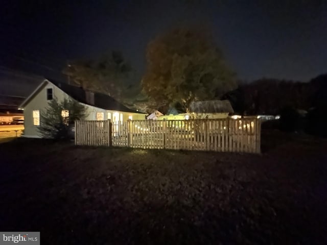 gate at twilight featuring fence